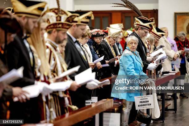 People dressed up in costums attend the jubilee celebration during the Carnival Mass at St Peter Canisius Church in Nijmegen on February 19 as the...