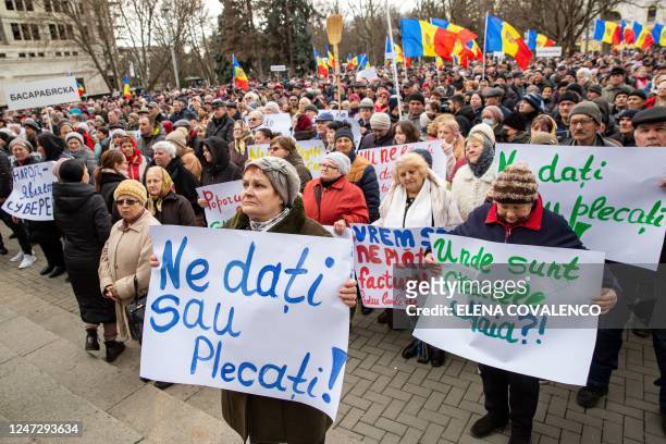Woman holds a sign theat reads, 'Give us or leave', during a protest against the Moldovan Government and their pro-EU President in Chisinau on...