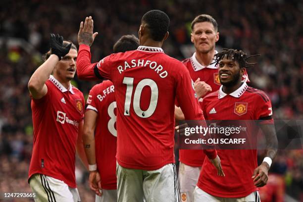 Manchester United's English striker Marcus Rashford celebrates scoring the opening goal during the English Premier League football match between...
