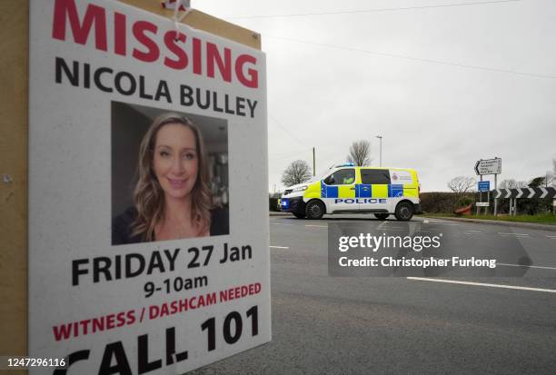 Police car blocks a road near the River Wyre in St Michael's on Wyre as a 'Missing' sign for Nicola Bulley adorns a telegraph pole in the foreground...