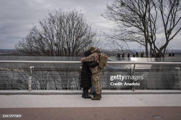 Soldier and a woman hug in Kyiv, Ukraine on February 19, 2023. As the first anniversary of the war nears, people in the capital of Ukraine lives the...