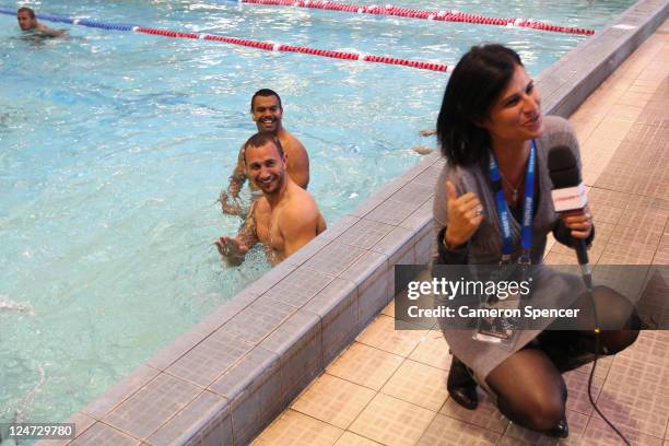 Quade Cooper and Kurtley Beale of the Wallabies splash as a reporter talks on pool deck during an Australia IRB Rugby World Cup 2011 recovery session...