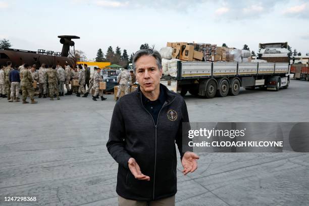 Secretary of State Antony Blinken addresses media, as US military personnel load aid onto a vehicle, at Incirlik Air Base near Adana, on February 19...