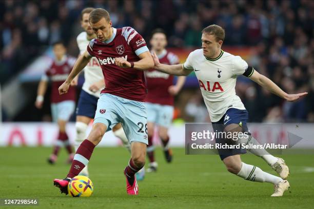 Tomas Soucek of West Ham United and Oliver Skipp of Tottenham Hotspur challenge during the Premier League match between Tottenham Hotspur and West...