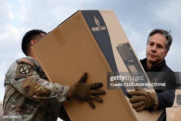 Secretary of State Antony Blinken helps US military personnel carrying aid, at Incirlik Air Base near Adana, on February 19 during his official visit...