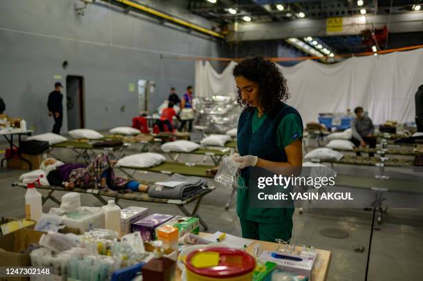 Medic prepares a drip aboard the Turkish warship TCG Sancaktar, ready to receive and treat victims of the February 6 earthquake, in the port of...