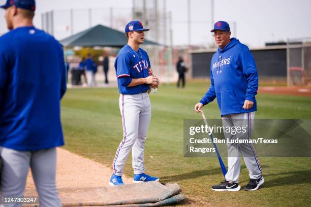 Jack Leiter talks with Greg Maddux during a Texas Rangers spring training team workout at Surprise Stadium on February 17, 2023 in Surprise, Arizona.