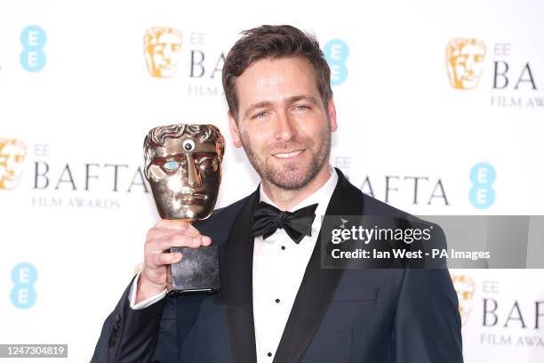 Paul Rogers poses with the award for Editing for film Everything Everywhere All At Once in the press room at the 76th British Academy Film Awards...