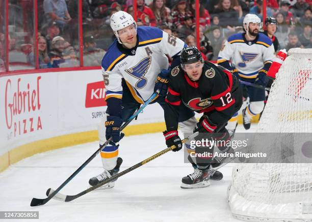 Alex DeBrincat of the Ottawa Senators battles for position against Colton Parayko of the St. Louis Blues at Canadian Tire Centre on February 19, 2023...