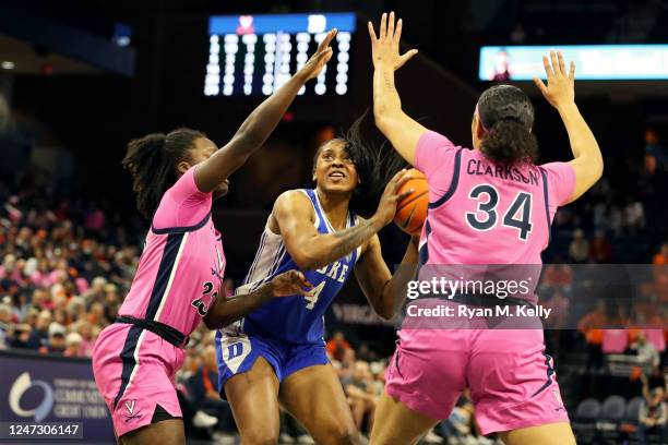 Elizabeth Balogun of the Duke Blue Devils shoots between Alexia Smith and London Clarkson of the Virginia Cavaliers in the first half during a game...