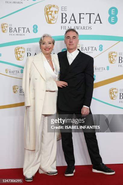 British actress Emma Thompson and her husband Greg Wise pose on the red carpet upon arrival at the BAFTA British Academy Film Awards at the Royal...