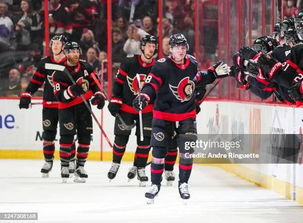 Tim Stützle of the Ottawa Senators celebrates his second period goal against the St. Louis Blues with teammates at the players bench at Canadian Tire...