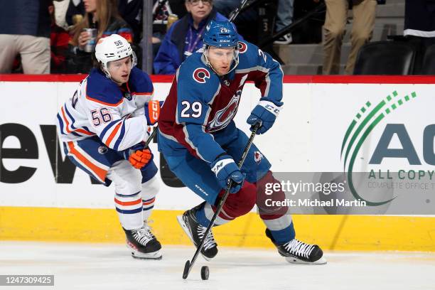 Nathan MacKinnon of the Colorado Avalanche skates against Kailer Yamamoto of the Edmonton Oilers at Ball Arena on February 19, 2023 in Denver,...