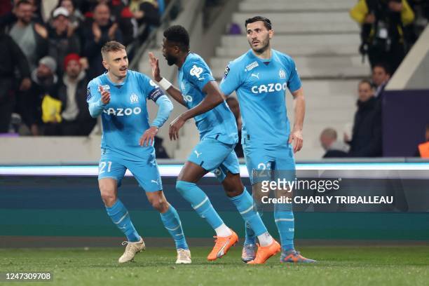 Marseille's Congolese defender Chancel Mbemba celebrates scoring his team's second goal with Marseille's French midfielder Valentin Rongier and...