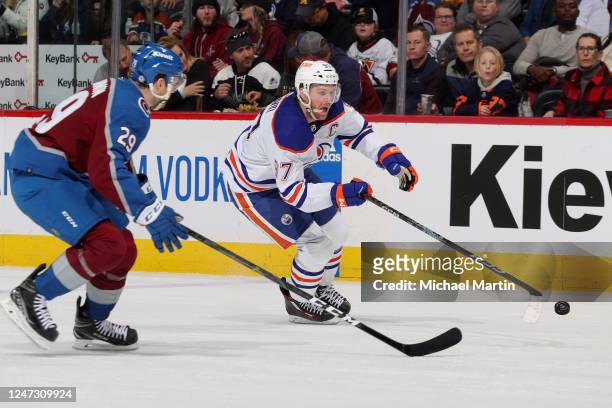 Connor McDavid of the Edmonton Oilers skates against Nathan MacKinnon of the Colorado Avalanche at Ball Arena on February 19, 2023 in Denver,...