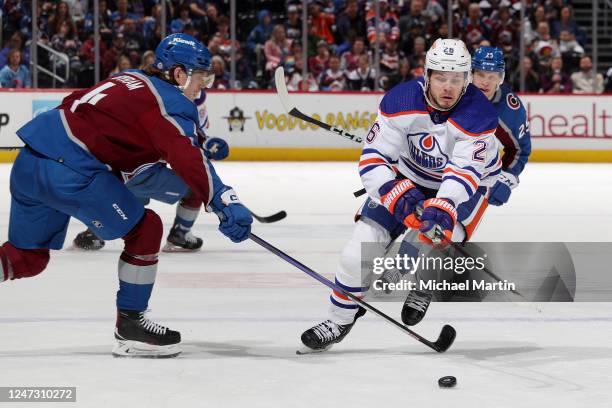 Mattias Janmark of the Edmonton Oilers skates against Bowen Byram of the Colorado Avalanche at Ball Arena on February 19, 2023 in Denver, Colorado.