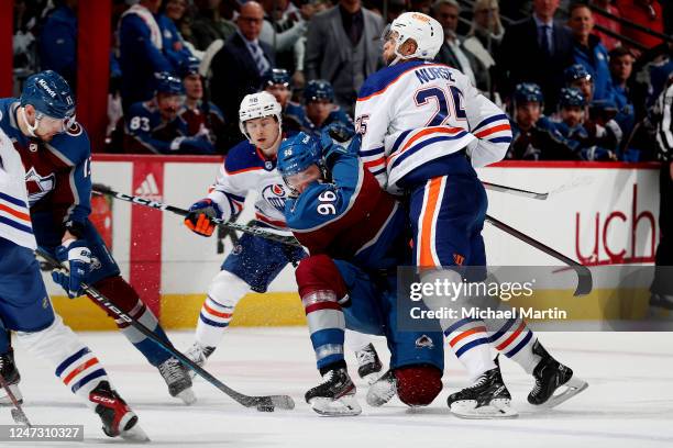 Valeri Nichushkin and Mikko Rantanen of the Colorado Avalanche skate against Kailer Yamamoto and Darnell Nurse of the Edmonton Oilers at Ball Arena...