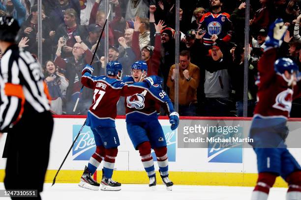 Compher and Mikko Rantanen of the Colorado Avalanche celebrate the game-winning goal against the Edmonton Oilers at Ball Arena on February 19, 2023...