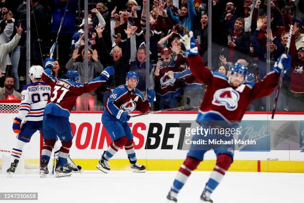 Compher, Mikko Rantanen and Devon Toews of the Colorado Avalanche celebrate the game-winning goal against the Edmonton Oilers at Ball Arena on...