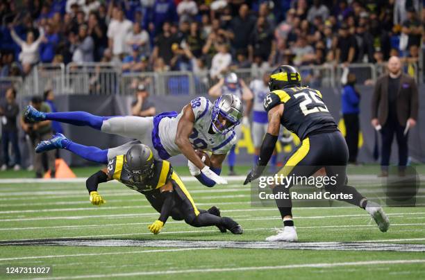 Hakeem Butler of the St. Louis Battlehawks is upended by Anthony Texada of the San Antonio Brahmas at the Alamodome on February 19, 2023 in San...