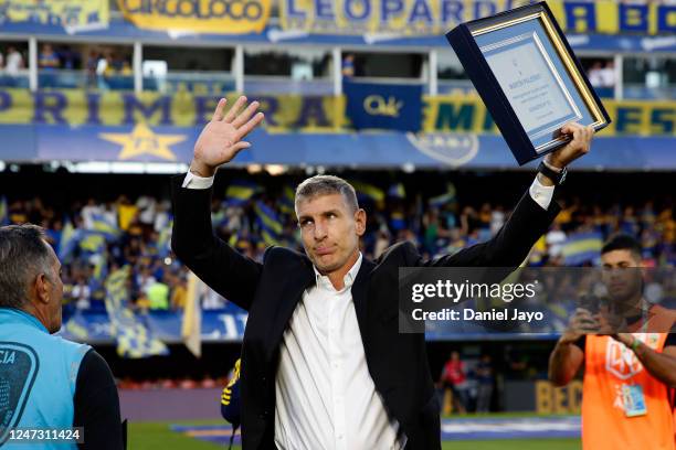 Martin Palermo, coach of Platense, and former player of Boca Juniors waves to fans after being honored before a match between Boca Juniors and...