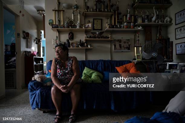 Maria Dolores Jaime gestures during a visit by Maria Carolina Borges , a volunteer member of the CONVITE civil association, in the Petare...