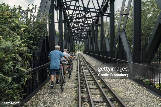 Cyclists on the Bukit Timah truss bridge on the Rail Corridor in Singapore, on Monday, Jan. 2, 2023. A former railway line running through the heart...
