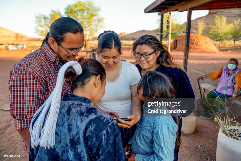 Navajo Family Spending Time Sharing Photos from a Smart Phone