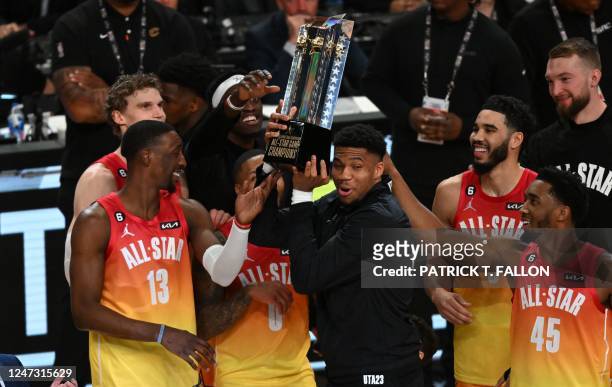 Milwaukee Bucks' Giannis Antetokounmpo lift the trophy after his team won the NBA All-Star game between Team Giannis and Team LeBron at the Vivint...