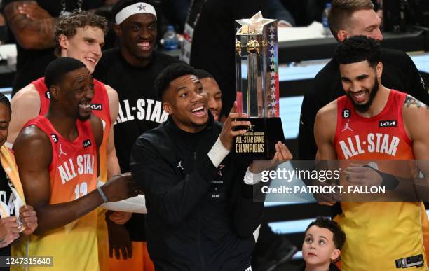 Milwaukee Bucks' Giannis Antetokounmpo lift the trophy after his team won the NBA All-Star game between Team Giannis and Team LeBron at the Vivint...