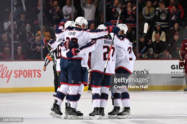 Patrik Laine of the Columbus Blue Jackets celebrates with Adam Boqvist and teammates after scoring a goal against the Arizona Coyotes during the...
