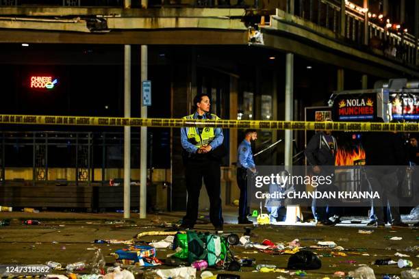 Police officers collect evidence at the scene of a shooting that occured during the Krewe of Bacchus parade in New Orleans, February 19, 2023. - New...