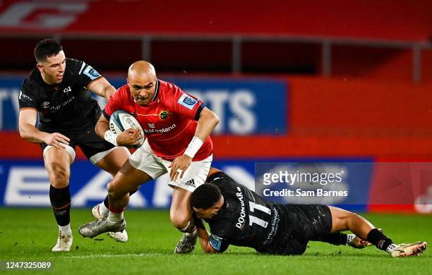 Limerick , Ireland - 17 February 2023; Simon Zebo of Munster is tackled by Keelan Giles, right, and Owen Watkin of Ospreys during the United Rugby...