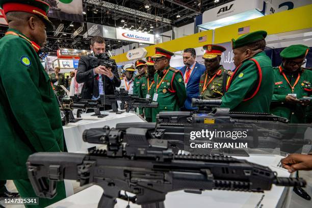 Tanzanian military officers attend a demonstration of assault rifles and other firearms during the International Defence Exhibtion at the Abu Dhabi...