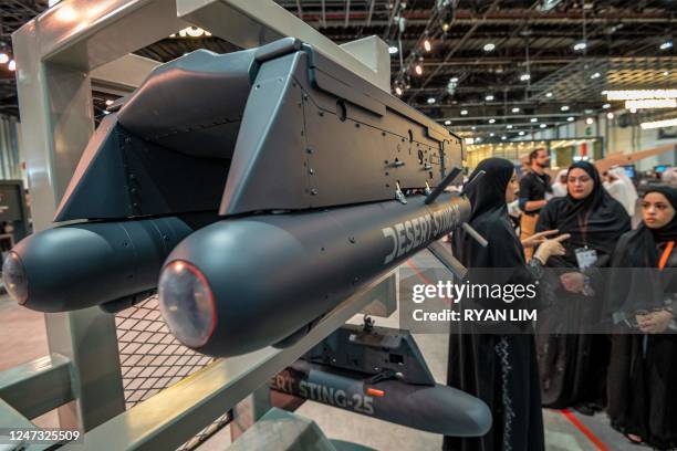 Visitors view a weapons platform carrying "Desert Sting 16" GPS and laser-guided smart micro munitions manufactured by Halcon Systems at the EDGE...