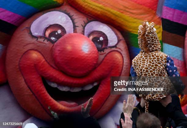 Revellers celebrate during a Rose Monday street carnival parade in Duesseldorf, western Germany, on February 20, 2023.