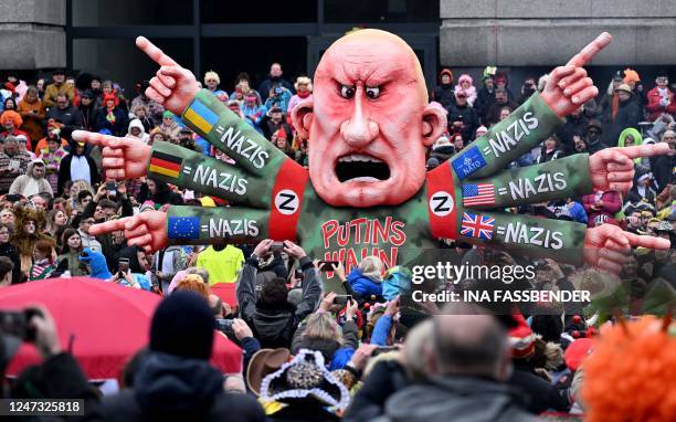 Revellers celebrate around a float featuring Russian oligarch Yevgeny Viktorovich Prigozhin, co-founder of the Russian state-backed mercenary company...