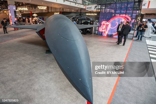 Visitors view an unmanned aerial vehicle at the EDGE pavilion during the International Defence Exhibtion at the Abu Dhabi International Exhibition...