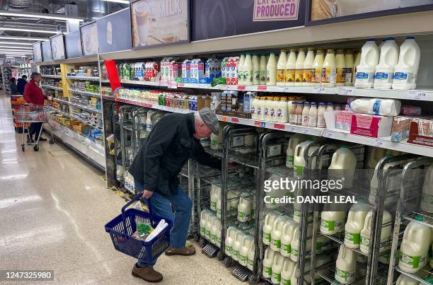 Customer shops for milk inside a Sainsbury's supermarket in east London on February 20, 2023. - British retail sales rebounded surprisingly in...