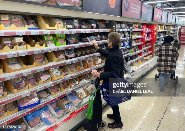 Customer shops for cooked meat inside a Sainsbury's supermarket in east London on February 20, 2023. - British retail sales rebounded surprisingly in...