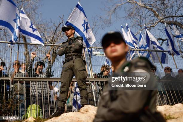 Officers from Israel's border police force patrol during a protest against prime minister Benjamin Netanyahus coalition government and proposed...