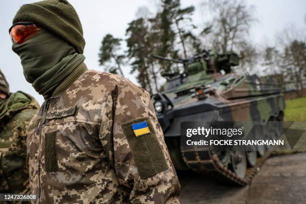 An Ukrainian soldier translator attends a press statement in front of an infantry fighting vehicle type Marder during the visit of the German Defence...