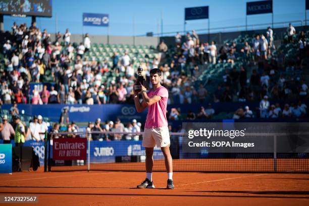 Carlos Alcaraz of Spain lifts the trophy after winning the Men's Singles Final against Cameron Norrie of Great Britain during day seven of the ATP...