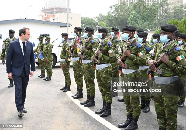 French Army Minister Sebastien Lecornu inspects a guard of honour upon his arrival at the Ivorian Ministry of Defence in Abidjan on Febuary 20, 2023.