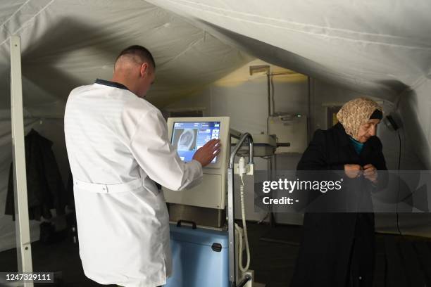 Doctor performs an x-ray on a patient at a Belarusian field hospital set up in the government-held northern city of Aleppo on February 20 following...