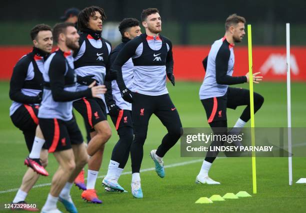 Liverpool's Scottish defender Andrew Robertson and teammates take part in a team training session at the AXA Training Centre in Liverpool, north-west...