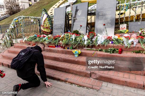 Hours after the visit of the President Joe Biden, Ukrainian men lie flowers in respect to the demonstrators killed during the Revolution of Dignity -...