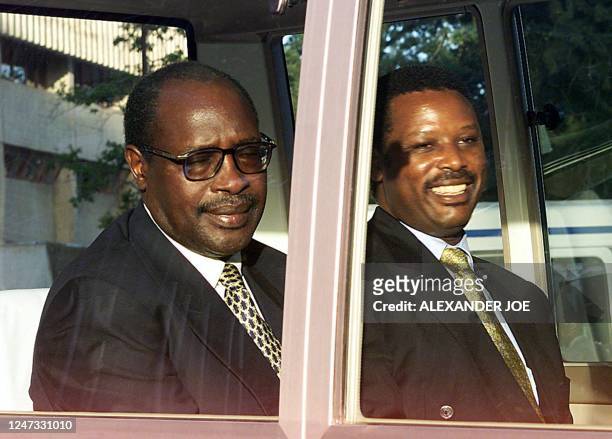 Rwandan President Pasteur Bizimongu and his Burundian counterpart Pierre Buyoya sit together in a minibus 21 February 2000 at the end of the opening...