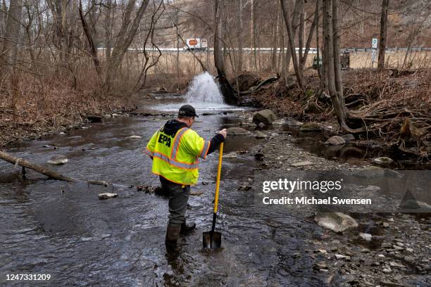 Ron Fodo, Ohio EPA Emergency Response, looks for signs of fish and also agitates the water in Leslie Run creek to check for chemicals that have...