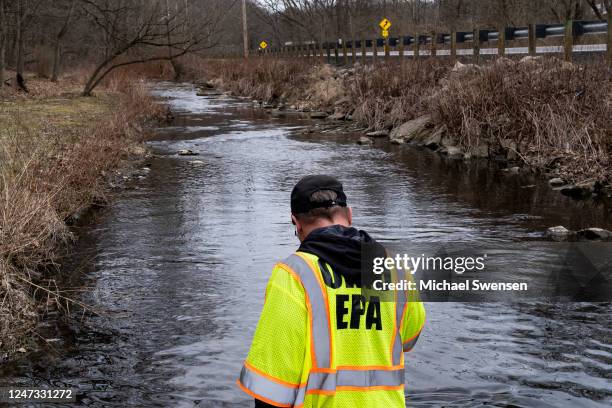 Ron Fodo, Ohio EPA Emergency Response, looks for signs of fish and also agitates the water in Leslie Run creek to check for chemicals that have...